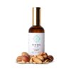 Kenzul Atlas Argan Oil 100ml amber glass bottle with gold pump cap beside argan nuts